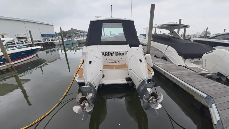 Slide: The Image of Rear view of a Sea Ray Sundancer 320 Outboard docked at a marina. - 28