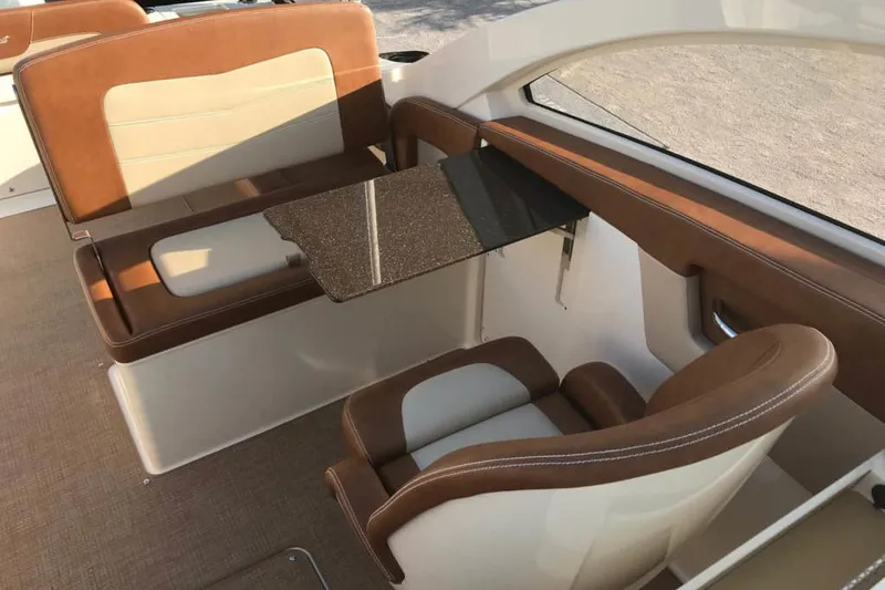 Slide: The Image of Manufacturer Provided Image: 2020 Scout 235 Dorado boat interior with brown and beige seating and a foldable table. - 6