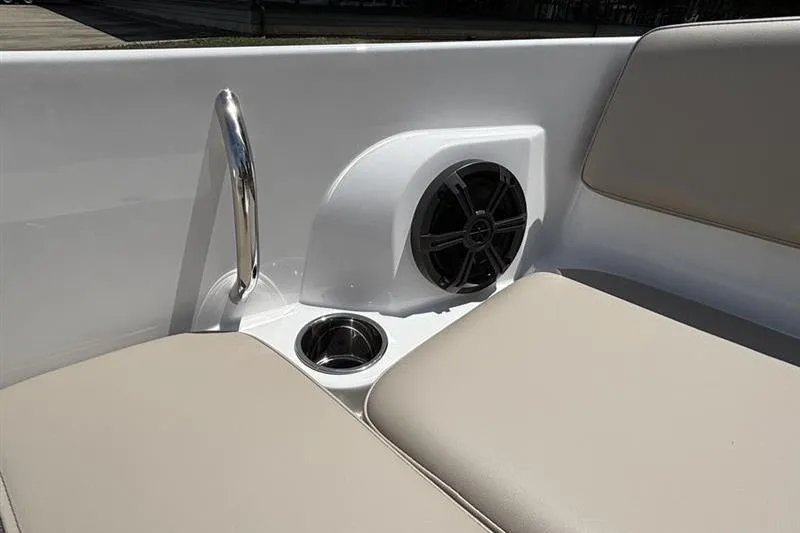 Slide: The Image of Interior of 2026 Tahoe 2150 boat featuring speaker, cup holder, and beige seating. - 13
