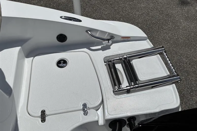 Slide: The Image of 2026 Tahoe 2150 boat swim platform with foldable ladder and storage compartment. - 15