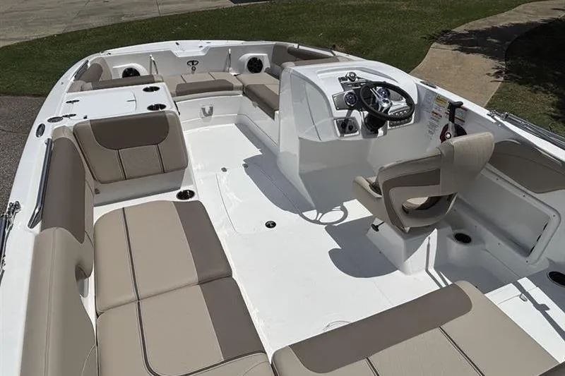 Slide: The Image of 2026 Tahoe 2150 boat interior with beige seating and modern steering console. - 7