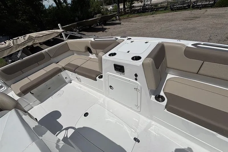 Slide: The Image of 2026 Tahoe 2150 boat interior with beige seating and storage compartments. - 9