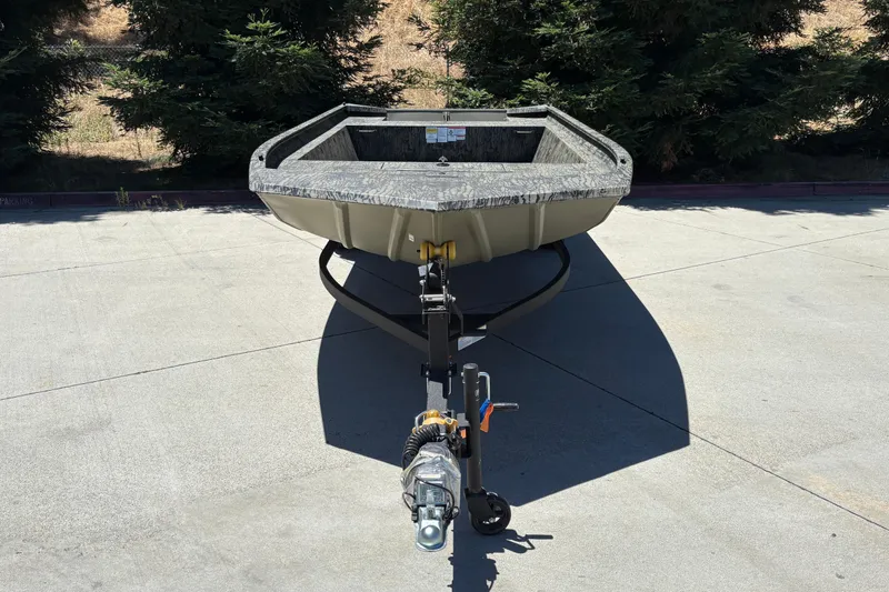 Slide: The Image of 2026 Tracker Grizzly 1860 Utility boat on trailer, parked outdoors. - 7