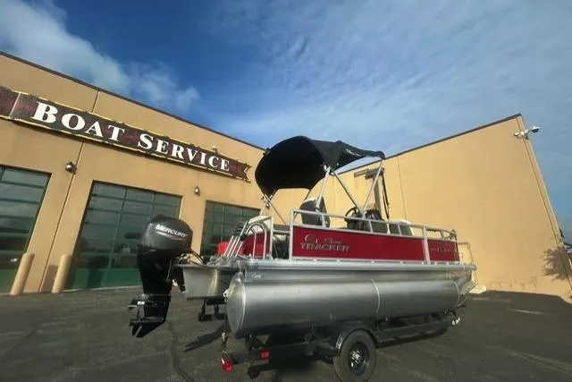 Slide: The Image of 2026 Sun Tracker Bass Buggy 16 XL Select pontoon boat at service center. - 2