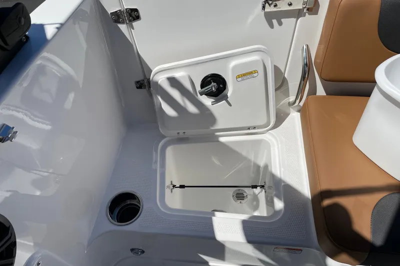 Slide: The Image of Interior of 2026 Tahoe 1950 boat featuring storage compartment and seating area. - 21