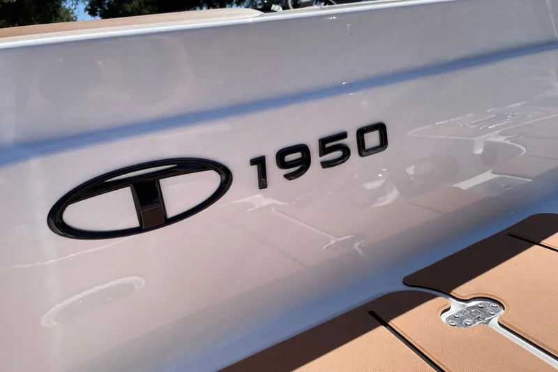 Slide: The Image of 2026 Tahoe 1950 boat logo on sleek white surface. - 7