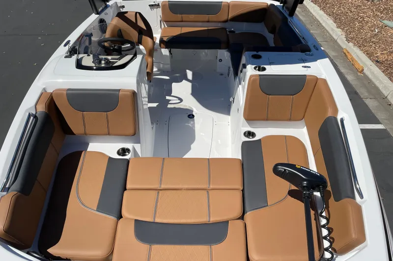 Slide: The Image of Modern 2026 Tahoe 1950 boat interior with tan and gray seating, steering wheel, and controls. - 16