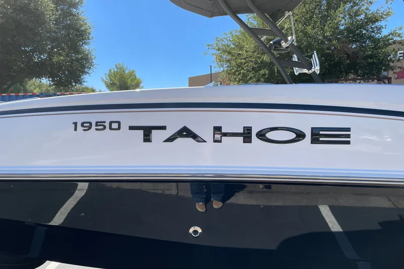Slide: The Image of 2026 Tahoe 1950 boat side view with logo and clear sky background. - 39