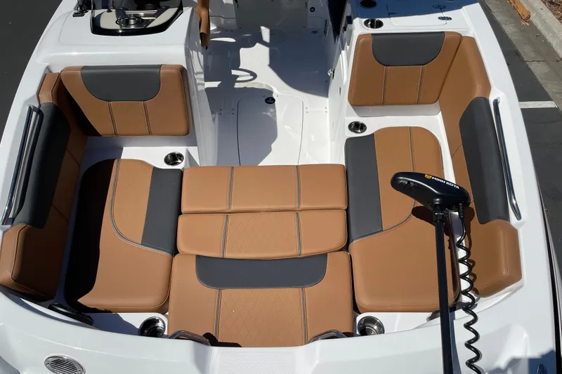 Slide: The Image of 2026 Tahoe 1950 boat interior with tan and gray seating, featuring a Minn Kota trolling motor. - 14