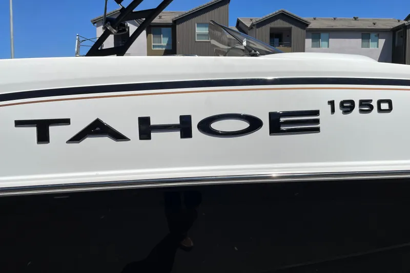 Slide: The Image of 2026 Tahoe 1950 boat model nameplate on white exterior, residential background. - 41