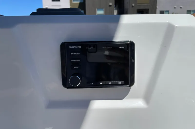 Slide: The Image of Kicker media center on Tahoe 1950 boat, 2026 model, with control buttons. - 33