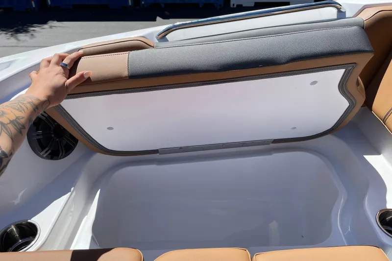Slide: The Image of 2026 Tahoe 1950 boat storage compartment with cushioned seating and cup holders. - 30