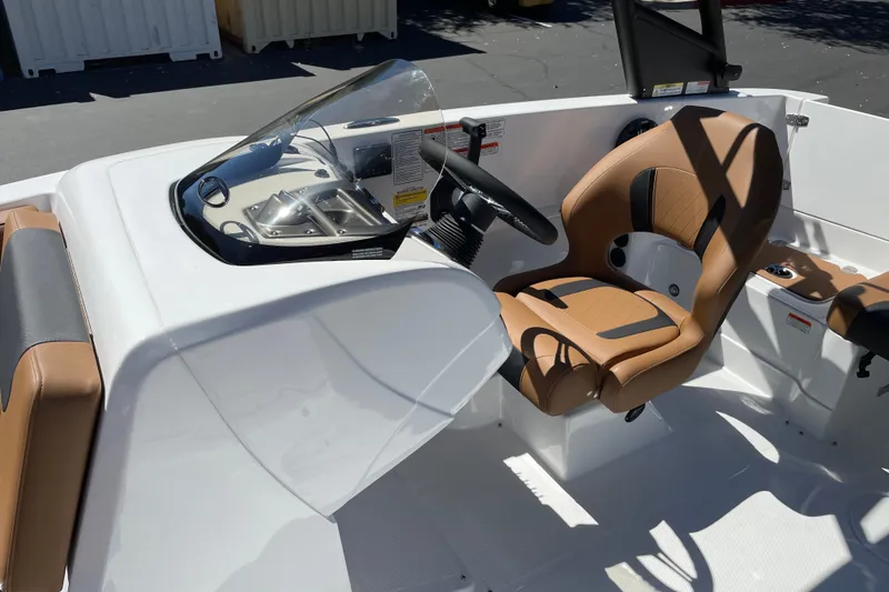 Slide: The Image of Interior of 2026 Tahoe 1950 boat with modern steering and tan seating. - 11