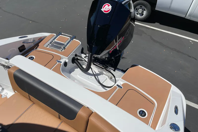 Slide: The Image of 2026 Tahoe 1950 boat interior with tan seating and powerful outboard motor. - 38