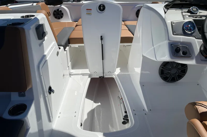 Slide: The Image of 2026 Tahoe 1950 boat interior with open storage compartment and seating area. - 24