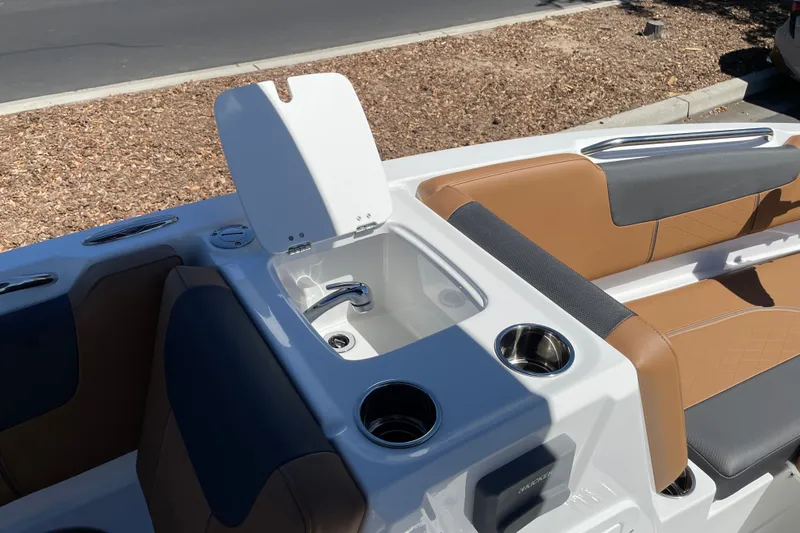 Slide: The Image of 2026 Tahoe 1950 boat interior with tan seating and built-in sink. - 26