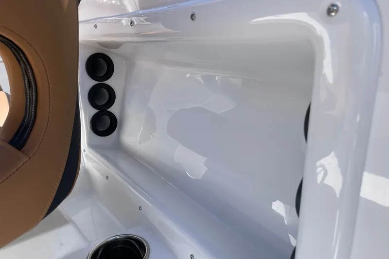 Slide: The Image of Interior view of 2026 Tahoe 1950 boat, featuring sleek white design and cup holders. - 22