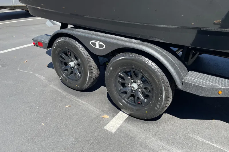 Slide: The Image of Trailer wheels of a 2026 Tahoe 1950 model, parked on asphalt. - 42