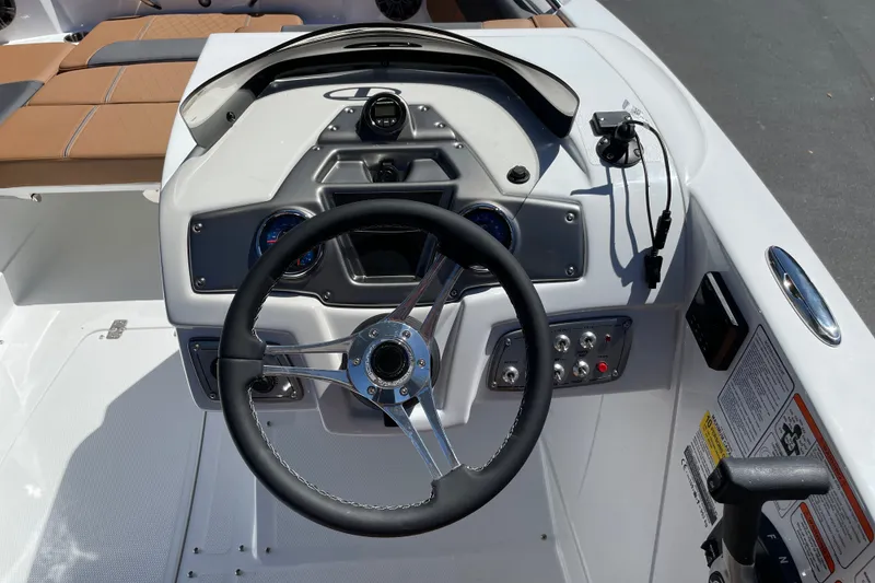 Slide: The Image of Steering console of a 2026 Tahoe 1950 boat with modern controls and gauges. - 35