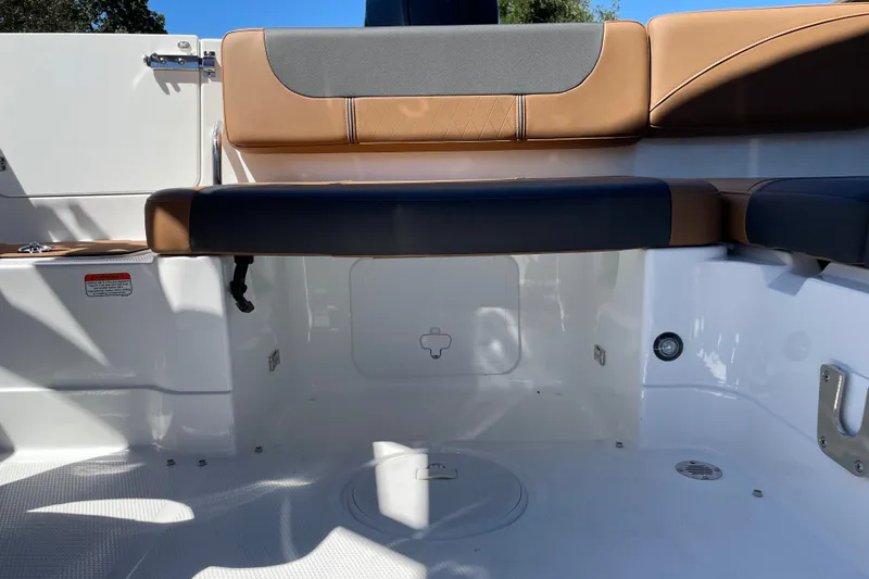 Slide: The Image of Interior of 2026 Tahoe 1950 boat with cushioned seating and storage area. - 17
