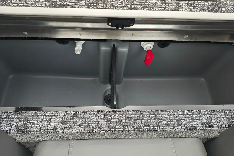 Slide: The Image of Livewell compartment in a 2026 Tracker Pro Team 175 boat, featuring plumbing and storage space. - 10
