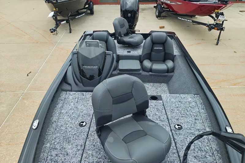 Slide: The Image of 2026 Tracker Pro Team 175 boat interior with gray seating and carpeted flooring. - 13