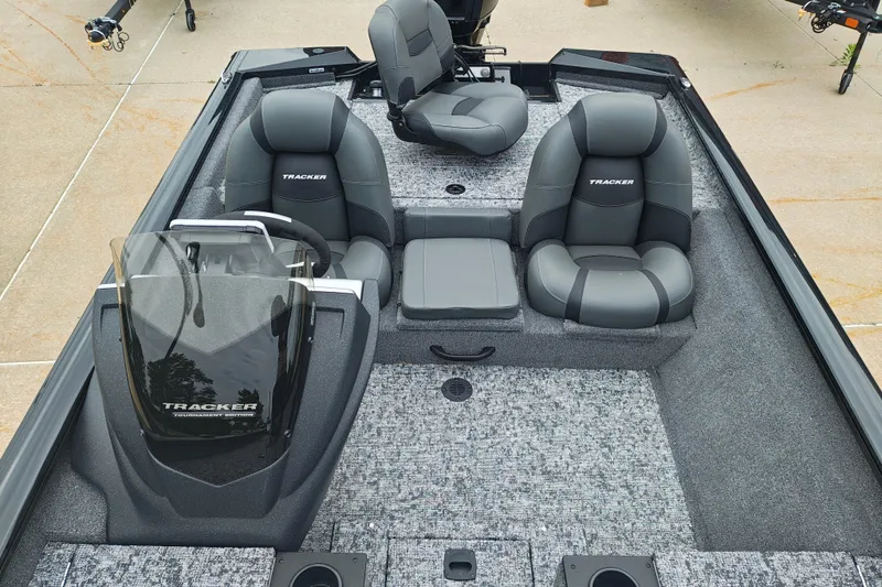 Slide: The Image of 2026 Tracker Pro Team 175 boat interior with gray seating and steering console. - 14