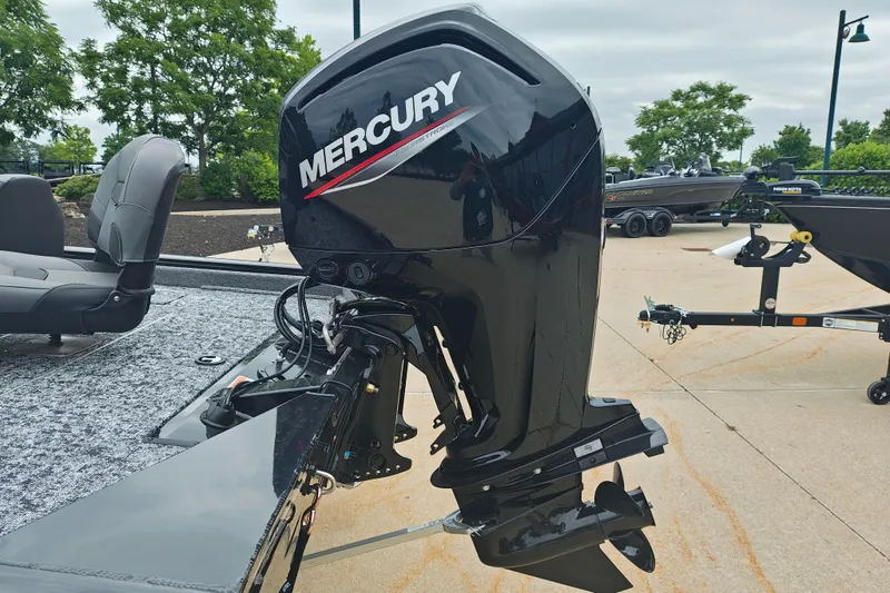 Slide: The Image of 2026 Tracker Pro Team 175 boat with Mercury outboard motor, parked on concrete. - 5