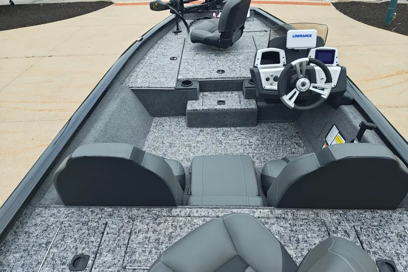 Slide: The Image of 2026 Tracker Pro Team 175 boat interior with steering console and seating. - 6