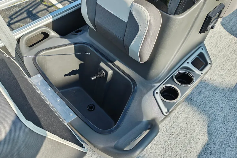 Slide: The Image of 2026 Sun Tracker Bass Buggy 18 DLX interior with storage compartment and cup holders. - 10