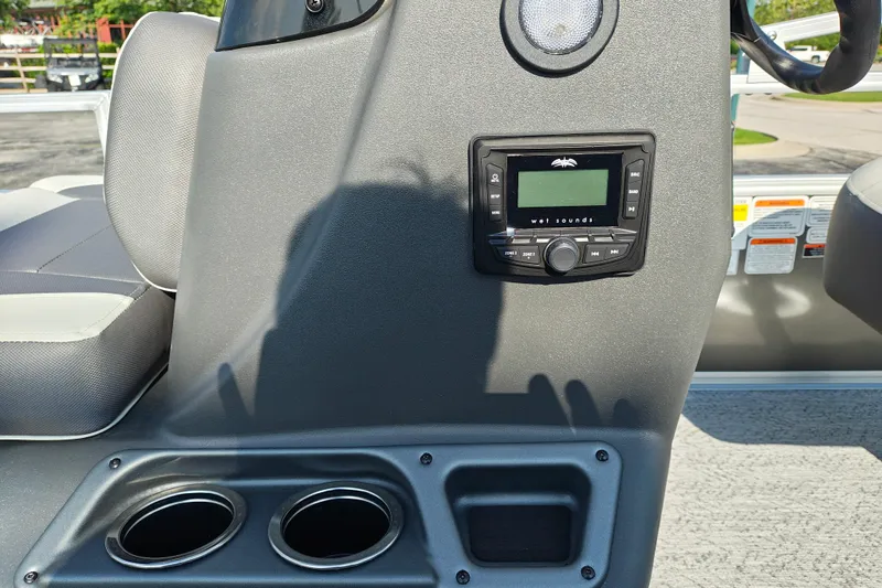 Slide: The Image of 2026 Sun Tracker Bass Buggy 18 DLX console with stereo system and cup holders. - 11