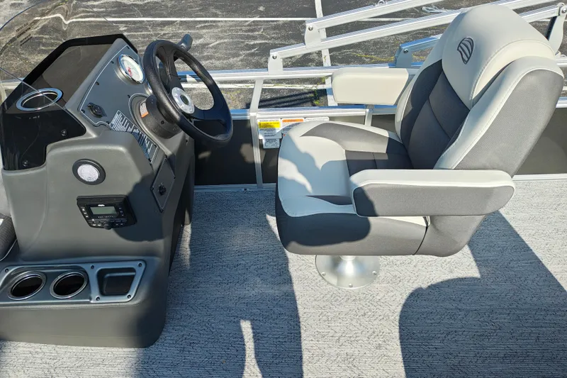 Slide: The Image of 2026 Sun Tracker Bass Buggy 18 DLX boat interior with steering console and captain's chair. - 12