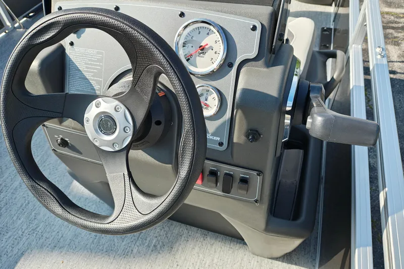 Slide: The Image of Steering console of 2026 Sun Tracker Bass Buggy 18 DLX with gauges and controls. - 14