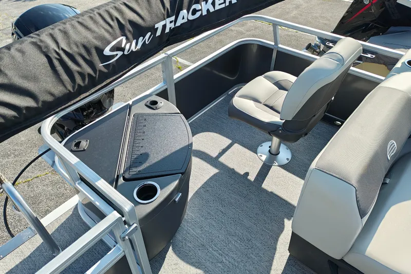 Slide: The Image of 2026 Sun Tracker Bass Buggy 18 DLX pontoon boat interior with seating and console. - 16