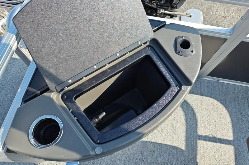 Slide: The Image of 2026 Sun Tracker Bass Buggy 18 DLX storage compartment with cup holder and rod holder. - 17
