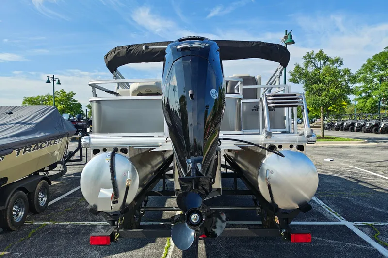 Slide: The Image of 2026 Sun Tracker Bass Buggy 18 DLX pontoon boat, rear view in parking lot. - 3