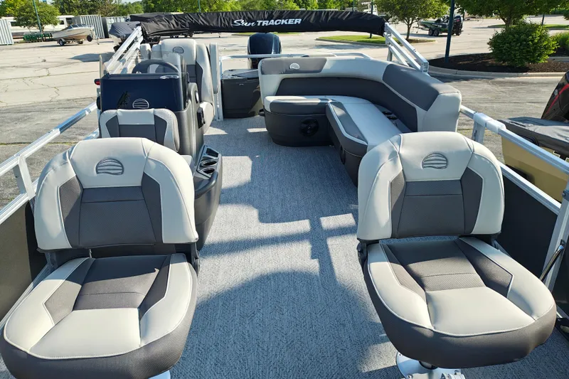 Slide: The Image of 2026 Sun Tracker Bass Buggy 18 DLX pontoon boat interior with plush seating and spacious layout. - 5