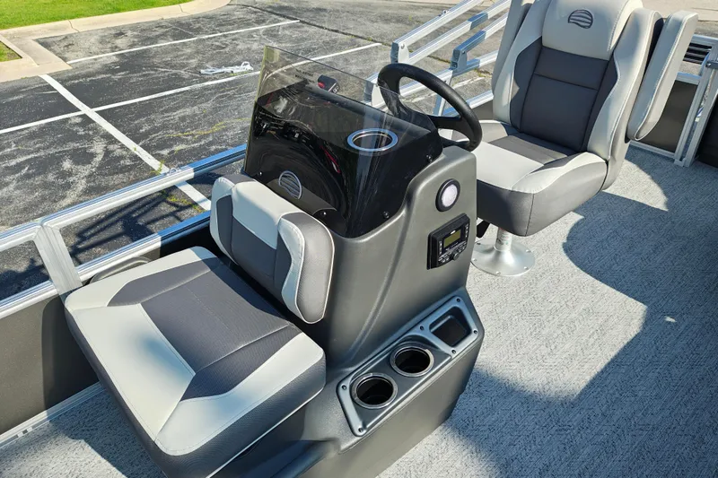 Slide: The Image of 2026 Sun Tracker Bass Buggy 18 DLX boat interior with steering console and seating. - 9