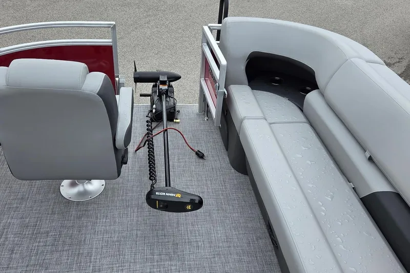 Slide: The Image of 2026 Sun Tracker SportFish 20 DLX interior with seating and trolling motor. - 2