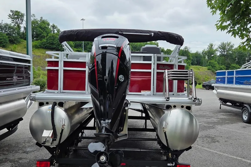 Slide: The Image of 2026 Sun Tracker SportFish 20 DLX pontoon boat with powerful outboard motor, parked outdoors. - 4