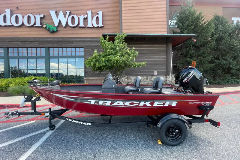 The Image of 2026 Tracker Super Guide V-16 SC boat on trailer outside Outdoor World store. - 0