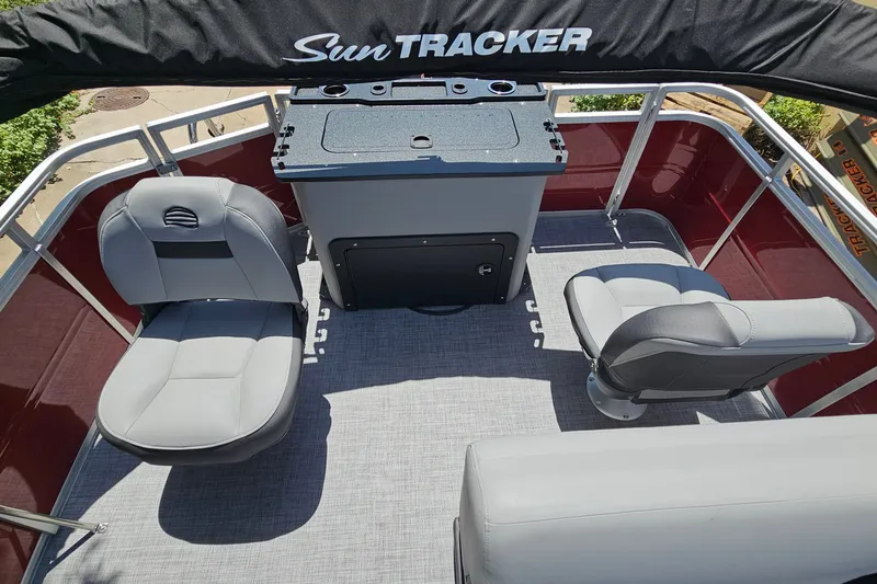 Slide: The Image of 2026 Sun Tracker SportFish 20 DLX pontoon boat interior with seating and console. - 14