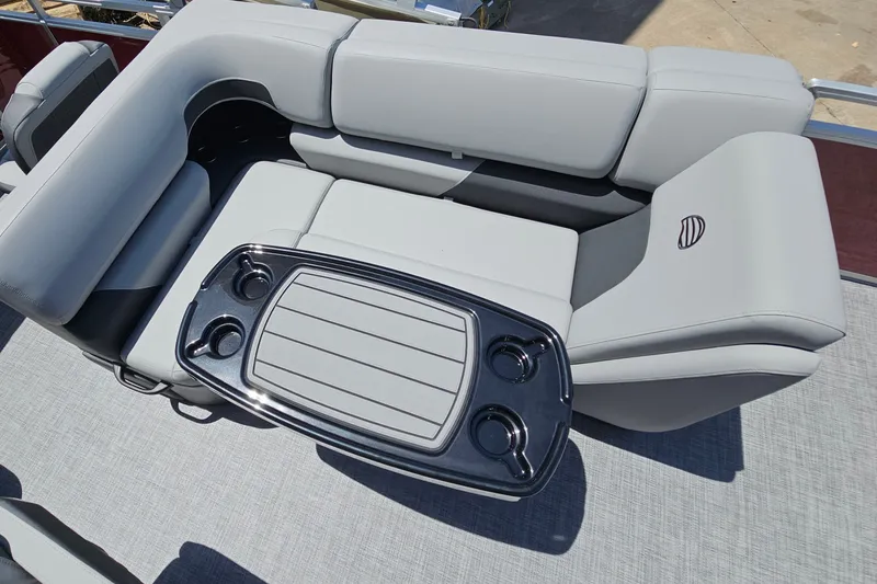 Slide: The Image of 2026 Sun Tracker SportFish 20 DLX boat interior with gray seating and a central table. - 13