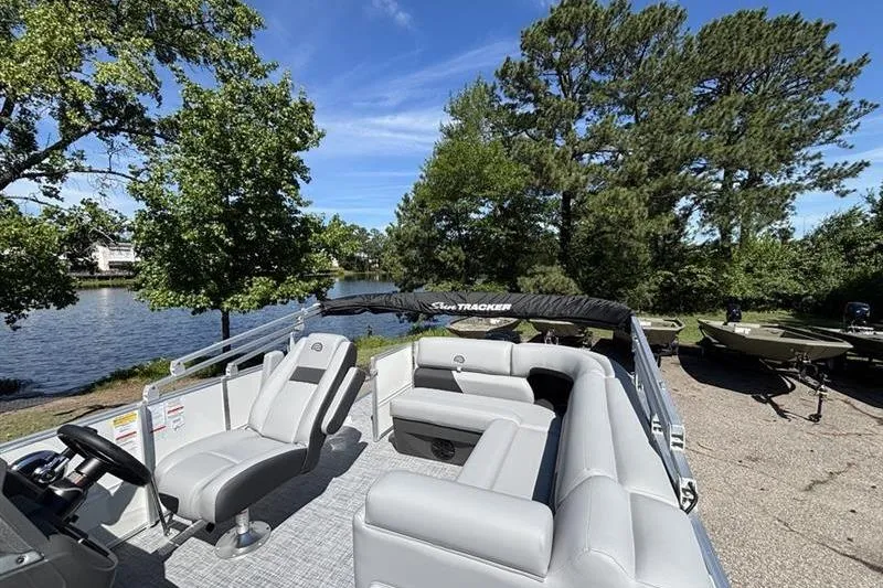 Slide: The Image of 2026 Sun Tracker Party Barge 20 DLX pontoon boat by a scenic lakeside. - 6