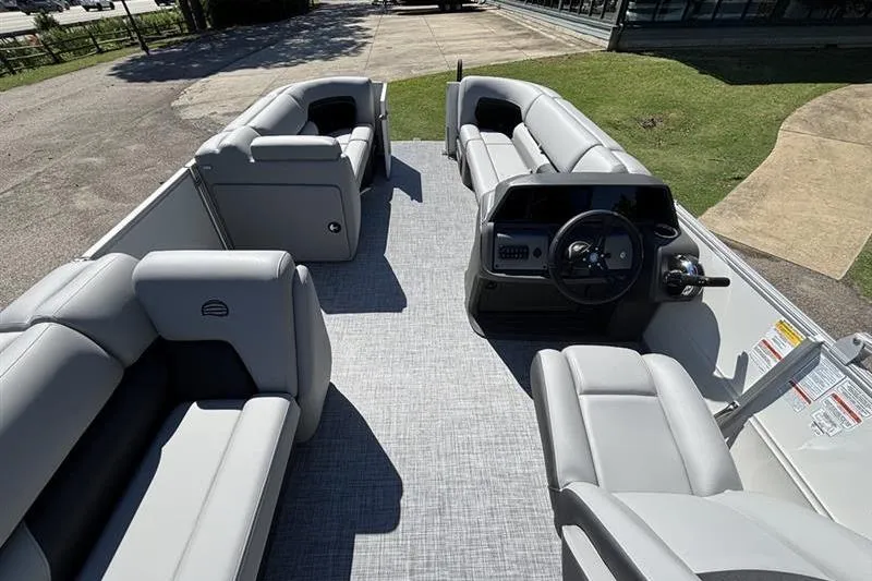 Slide: The Image of 2026 Sun Tracker Party Barge 20 DLX pontoon boat interior with plush seating and steering console. - 7
