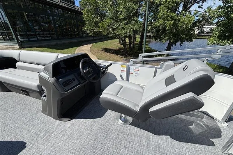 Slide: The Image of 2026 Sun Tracker Party Barge 20 DLX interior with comfortable seating and steering console. - 8