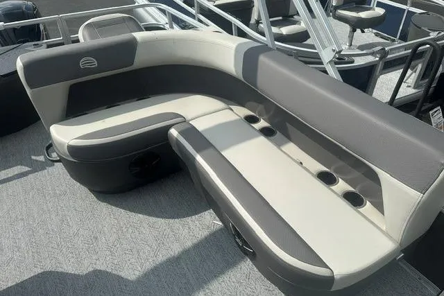 Slide: The Image of 2026 Sun Tracker Bass Buggy 18 DLX pontoon boat seating area with cup holders. - 7