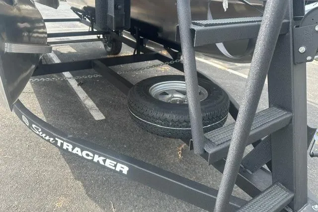 Slide: The Image of 2026 Sun Tracker Bass Buggy 18 DLX trailer with spare tire and sturdy steps. - 4