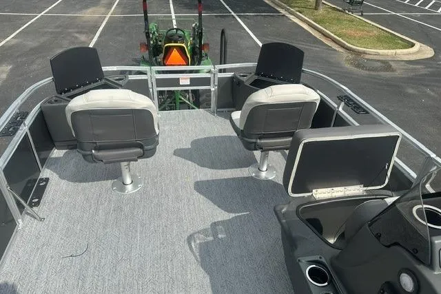 Slide: The Image of 2026 Sun Tracker Bass Buggy 18 DLX pontoon boat interior with seating and storage. - 9