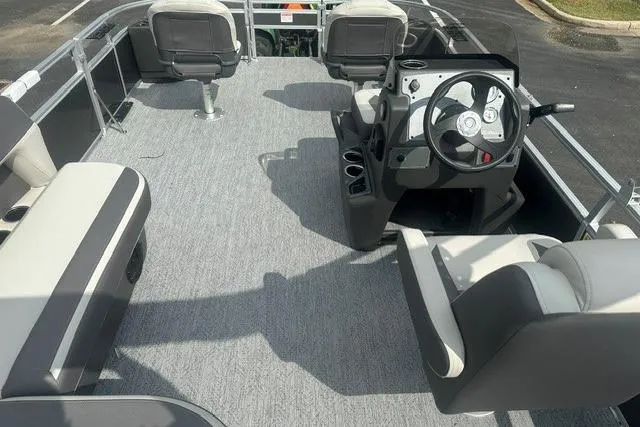 Slide: The Image of 2026 Sun Tracker Bass Buggy 18 DLX pontoon boat interior with seating and steering console. - 10
